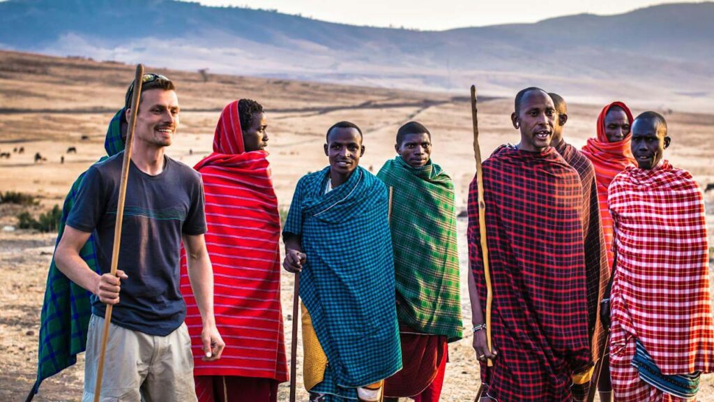 A Guide to African Cultural Celebrations: 8 Sacred Celebrations Across the Continent 30 Maasai Warriors with a Tourist
